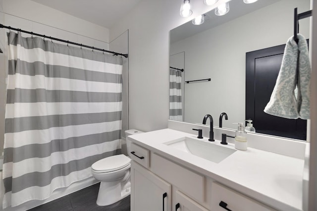 bathroom featuring vanity and toilet