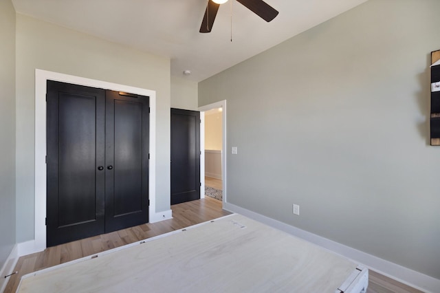 bedroom with a closet, ceiling fan, and light hardwood / wood-style flooring