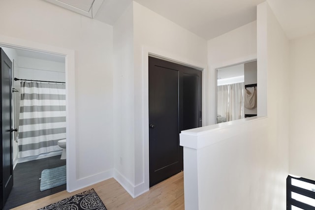 hallway with light hardwood / wood-style floors