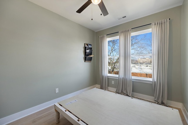 unfurnished bedroom with ceiling fan and light wood-type flooring