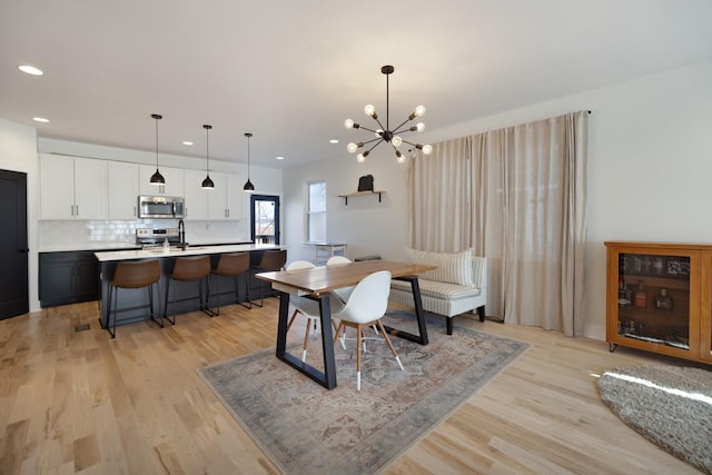 dining room featuring light hardwood / wood-style flooring and a chandelier