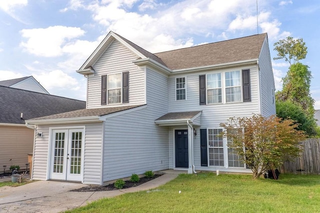 view of front of home with a front yard and french doors