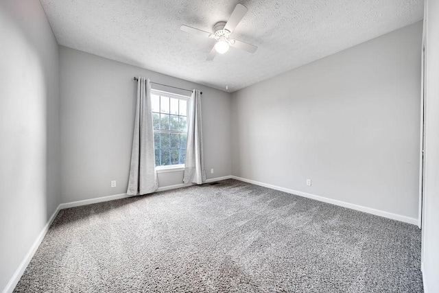 spare room featuring a textured ceiling, carpet flooring, and ceiling fan