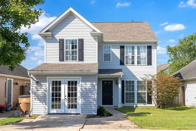 view of front of property featuring a front lawn and french doors