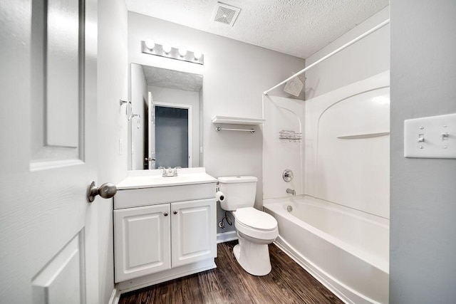 full bathroom with a textured ceiling, wood-type flooring, vanity, toilet, and shower / bathtub combination