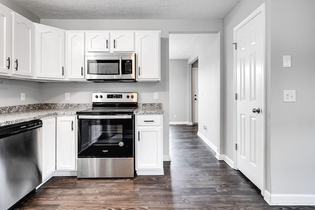 kitchen with a textured ceiling, dark wood-type flooring, white cabinetry, and appliances with stainless steel finishes