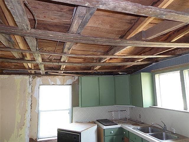 kitchen featuring sink and green cabinetry