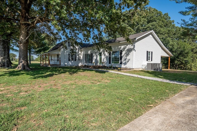 ranch-style house featuring central AC unit, a front yard, and covered porch