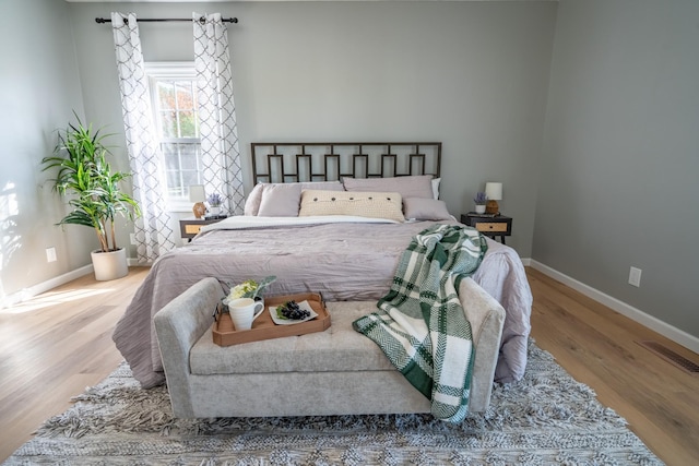 bedroom with hardwood / wood-style floors