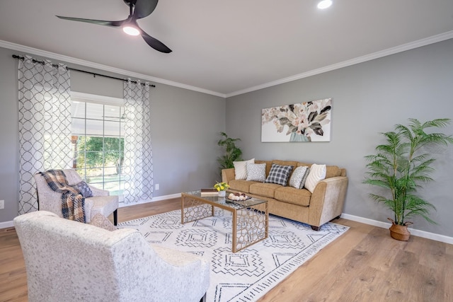 living room with ceiling fan, ornamental molding, and light hardwood / wood-style floors