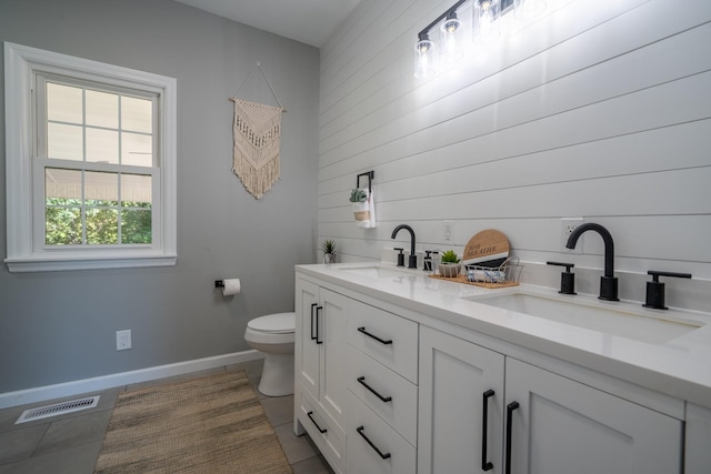 bathroom featuring vanity, tile patterned floors, and toilet