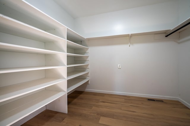 walk in closet featuring dark hardwood / wood-style flooring