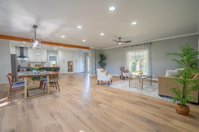 dining room with crown molding, ceiling fan, and light hardwood / wood-style floors