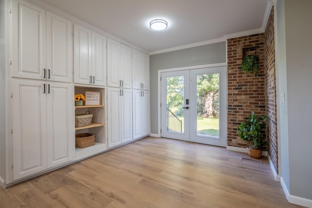 mudroom with crown molding, light hardwood / wood-style flooring, and french doors