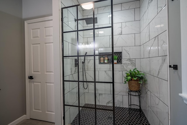 bathroom with tile patterned flooring and tiled shower