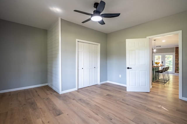 unfurnished bedroom with a closet, ceiling fan, and light wood-type flooring