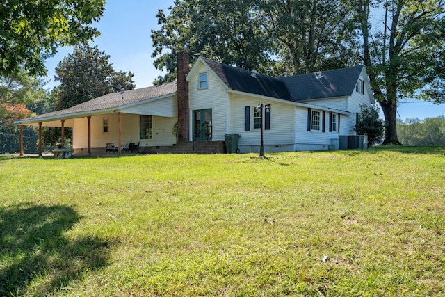 rear view of property with a yard