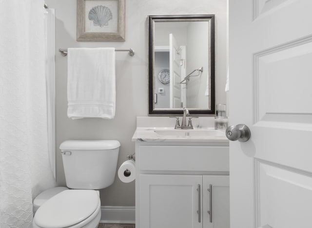 bathroom featuring toilet and vanity