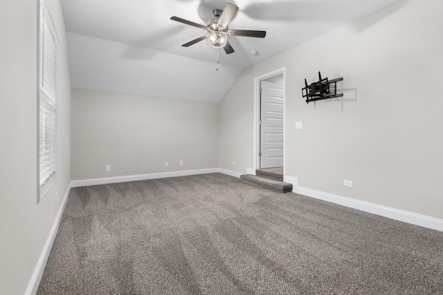 interior space with carpet flooring, vaulted ceiling, and ceiling fan