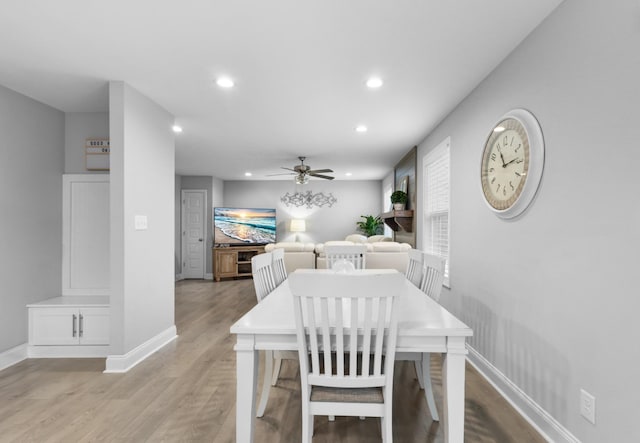 dining area with light hardwood / wood-style floors and ceiling fan