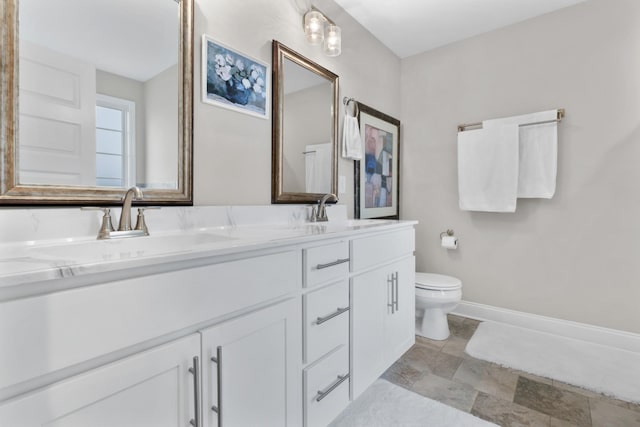 bathroom featuring toilet and vanity