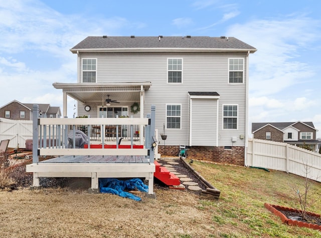 rear view of house featuring a wooden deck, a lawn, and ceiling fan