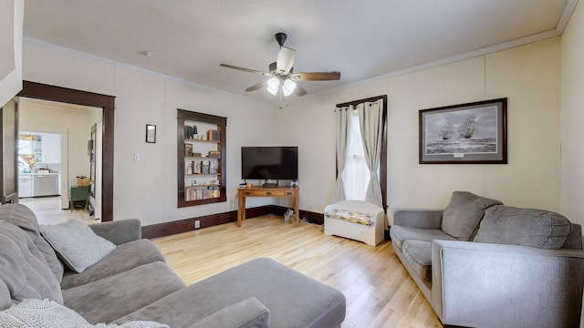 living room with light wood-type flooring, ceiling fan, and crown molding