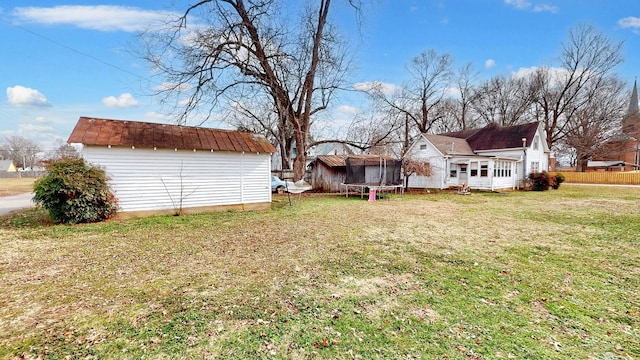 view of yard with a shed and a trampoline