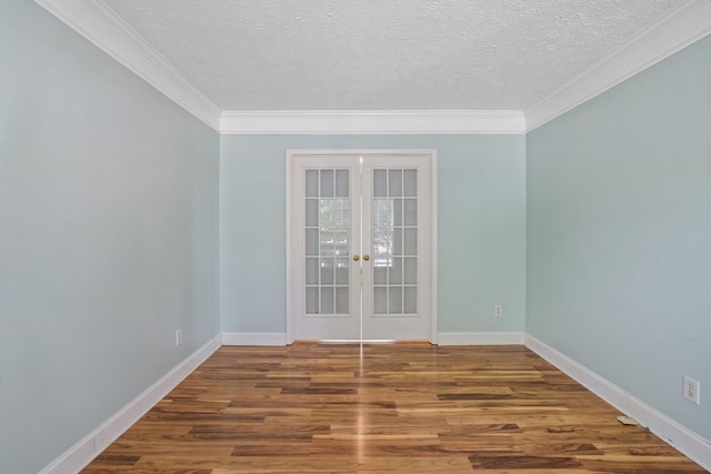 spare room with ornamental molding, hardwood / wood-style flooring, a textured ceiling, and french doors