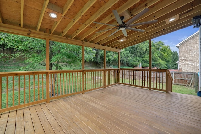 wooden deck featuring ceiling fan and a lawn