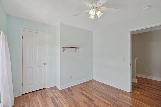 unfurnished room featuring hardwood / wood-style flooring, a textured ceiling, and ceiling fan