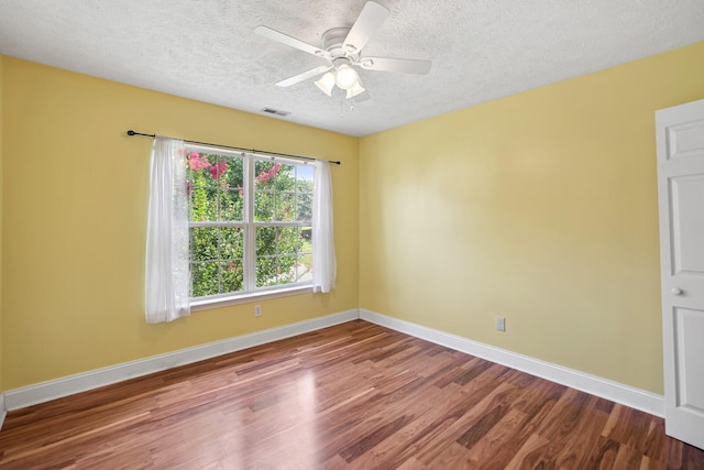 empty room featuring hardwood / wood-style flooring, ceiling fan, and a textured ceiling