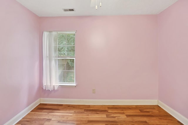 empty room with light hardwood / wood-style flooring