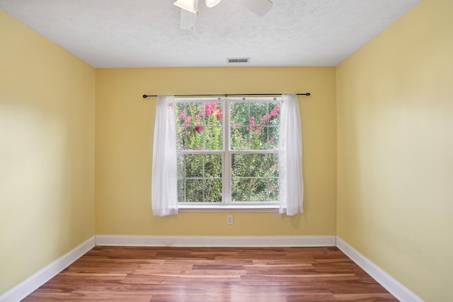 unfurnished room featuring ceiling fan, a textured ceiling, and wood-type flooring