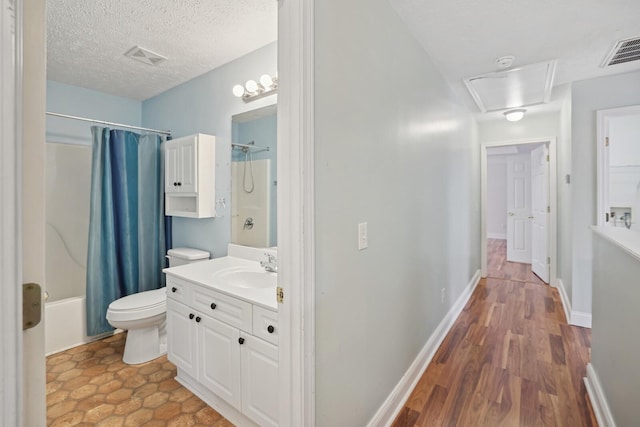 full bathroom featuring toilet, a textured ceiling, wood-type flooring, shower / tub combo with curtain, and vanity