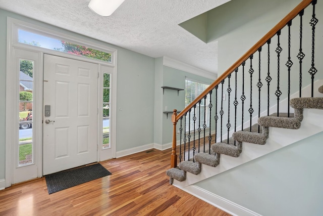 entrance foyer featuring wood-type flooring and a textured ceiling