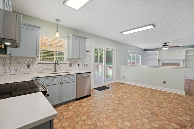 kitchen with stainless steel dishwasher, sink, decorative light fixtures, gray cabinets, and a textured ceiling