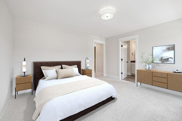 carpeted bedroom featuring connected bathroom