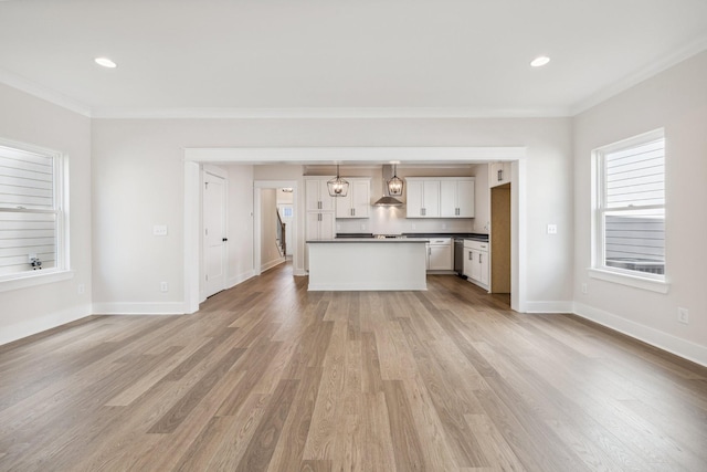 unfurnished living room featuring light hardwood / wood-style flooring and ornamental molding