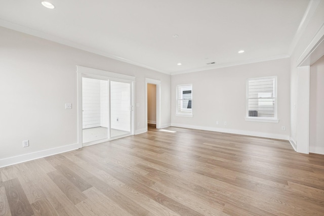 unfurnished living room featuring light hardwood / wood-style flooring and ornamental molding