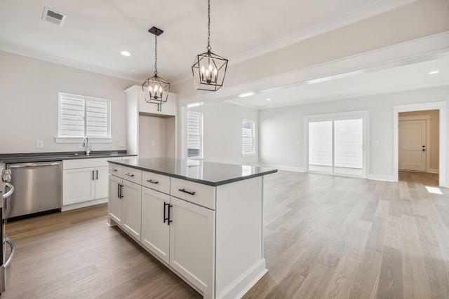 kitchen with white cabinets, dishwasher, sink, hanging light fixtures, and light wood-type flooring