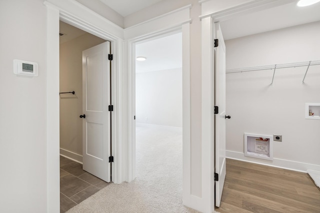 clothes washing area with hookup for a washing machine, electric dryer hookup, and carpet flooring