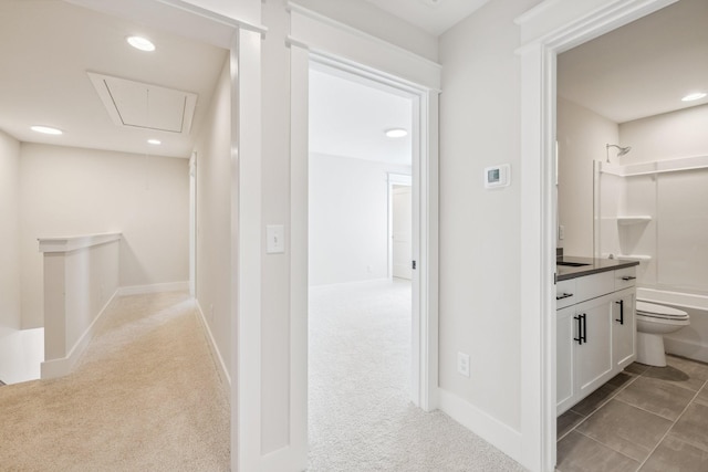 hallway featuring light colored carpet