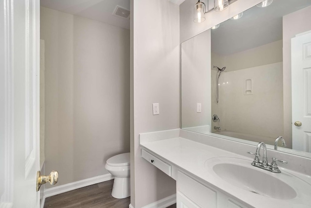 full bathroom with wood-type flooring, toilet, shower / bathing tub combination, and vanity