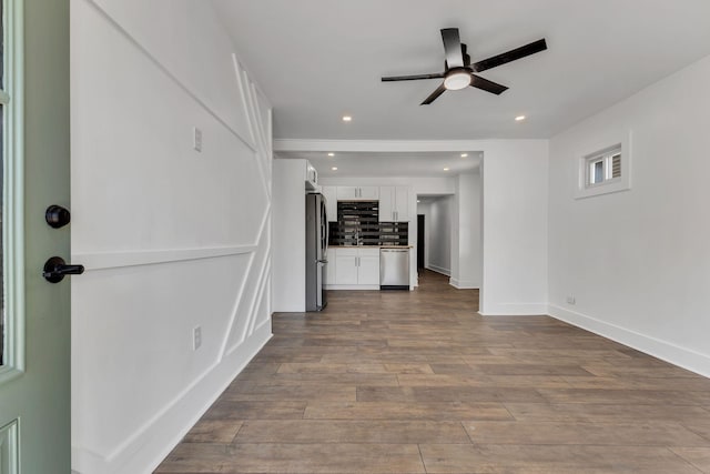 unfurnished living room with sink, light hardwood / wood-style flooring, and ceiling fan