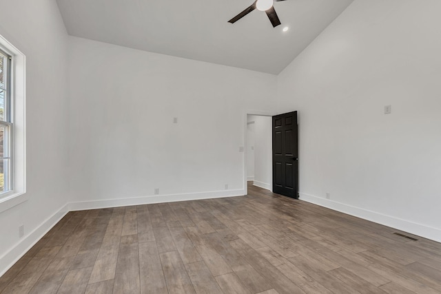 unfurnished room with high vaulted ceiling, light hardwood / wood-style floors, and ceiling fan