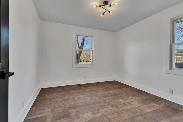 unfurnished room with hardwood / wood-style flooring