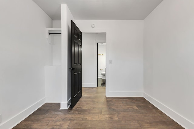 spare room with dark wood-type flooring