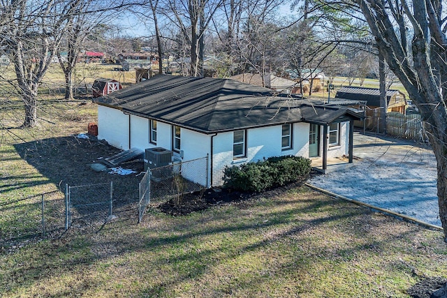 view of home's exterior featuring cooling unit and a lawn