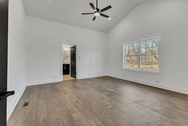 spare room with ceiling fan, high vaulted ceiling, and light hardwood / wood-style floors